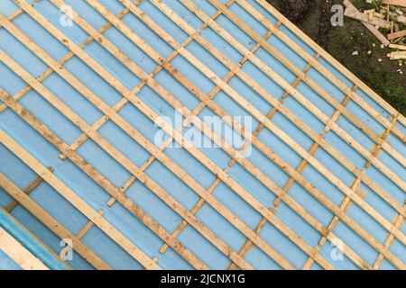 Aerial view of a brick house with wooden roof frame under construction Stock Photo