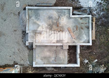 Aerial view of building works of new house concrete foundation on construction site Stock Photo