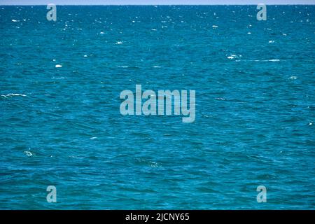 Closeup seascape surface of blue sea water with small ripple waves Stock Photo