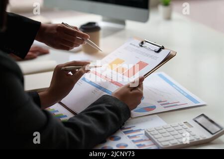 Group of Businesswoman and Accountant checking data document on digital tablet for investigation of corruption account. Anti Bribery concept. Stock Photo
