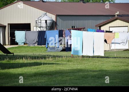 Clothes hanging out to dry on a line outside the home of an Amish family near Arthur Illinois Stock Photo