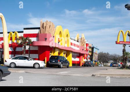 Cars waiting in a line of a drive thur window at a McDonalds restaurant Stock Photo