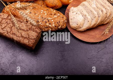 Different types of bread. Assortment of bread on grey background. Stock Photo