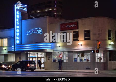 Cars parked in front of the Greyhound bus station, with blue neon lights, in downtown Dallas, Texas ca. 2015 Stock Photo