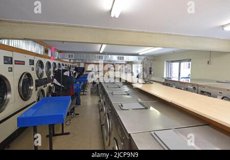 Customers doing their laundry in a traditional coin operated laundormat in Grapevine, Texas Stock Photo