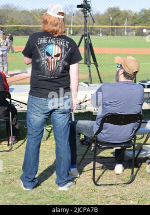 A Gen Z man (Generation Z) with long red hair wearing a second amendment "Come and Take it" t-shirt Stock Photo