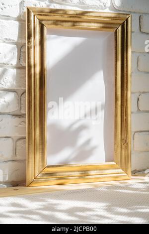 Photo frames on floor over white brick wall Stock Photo