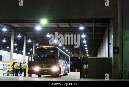 Regional bus parked inside the Dallas Texas Greyhound bus station at night Stock Photo