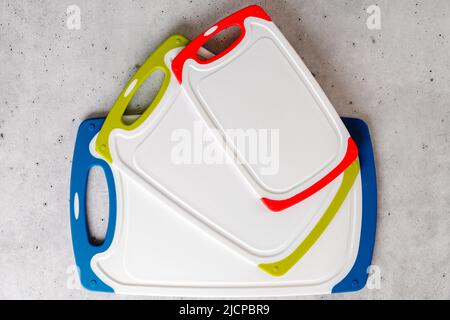 Set of plastic cutting boards in different colors and sizes close-up, copy space Stock Photo
