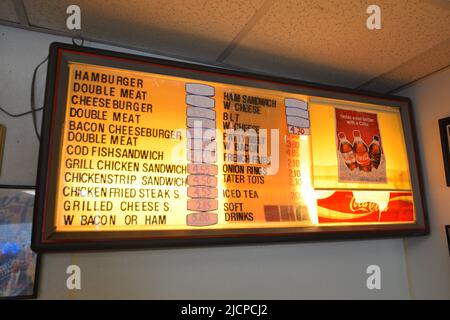 Interior of the Record Grill, a small hole in the wall restaurant, in downtown Dallas, Texas. Close up of the menu sign which has new prices taped ove Stock Photo