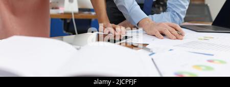Business man and woman studying documents at table in office closeup Stock Photo