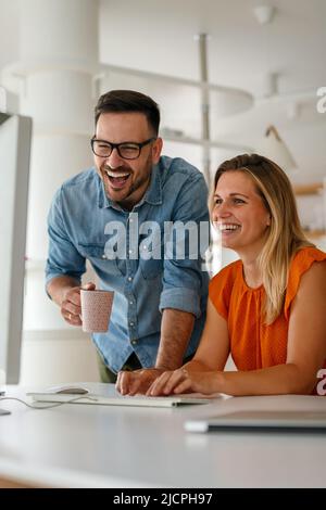 Programmers cooperating at IT company developing apps Stock Photo