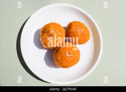 Indian Popular sweet dish item called Motichur Laddu or motichoor ke ladoo made of chickpeaflour or besan batter tiny drops deepfried and then rolled Stock Photo
