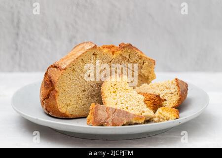 typical portuguese corn bread on gray plate on gray ceramic Stock Photo