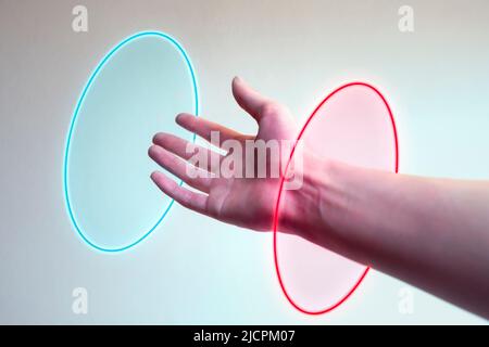 Hand entering in a neon light as a gate for metaverse Stock Photo