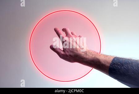 Hand entering in a neon light as a gate for metaverse Stock Photo
