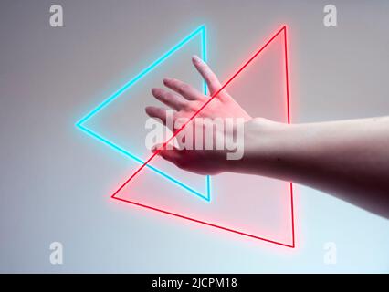 Hand entering in a neon light as a gate for metaverse Stock Photo