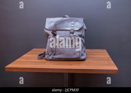 Canvas backpack on wood table. Unisex bag Stock Photo