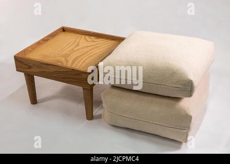 Wooden nightstand with handmade felt pillows isolated on white background Stock Photo