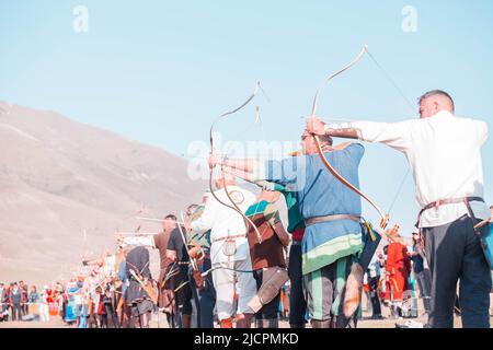 Isyk-Kul, Kyrgyzstan - September ‎29, ‎2018: Men with arrows in bows focused on hitting a target Stock Photo