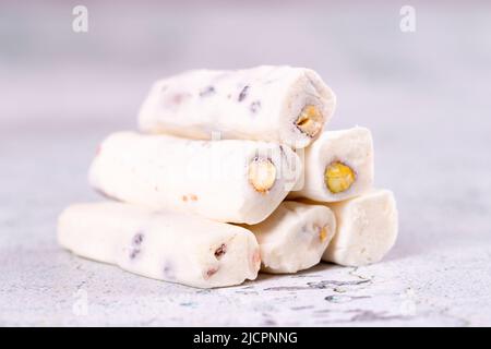 Turkish delight with pistachio milk. Turkish delight with milk flavor on a concrete floor. Traditional Turkish delicacies. close up Stock Photo