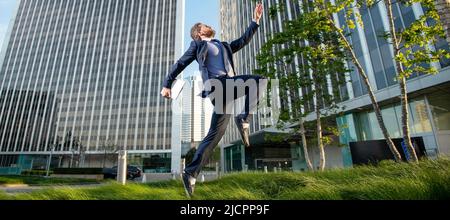 agile business. professional network administrator hold computer. boss with modern laptop. Man jumping, banner with copy space. Stock Photo