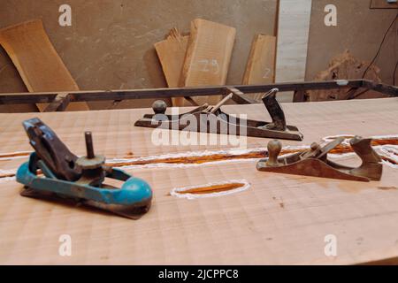 Old jointer planes laying on wood table. Woodworking tools on wooden table. Carpentry workshop Stock Photo
