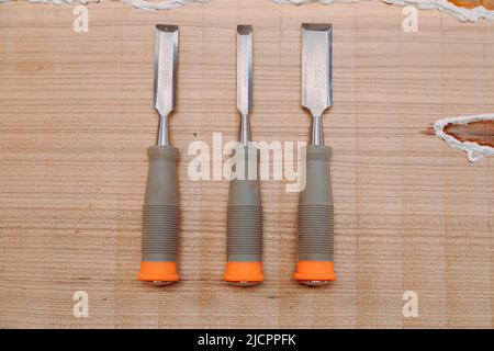 Set of chisels on wooden table. Tools for wood work Stock Photo