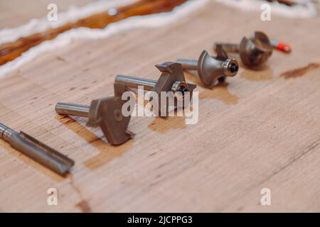 Set of steel router bit for milling cutter on a wooden table Stock Photo
