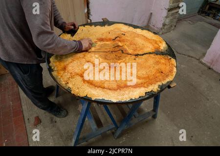 Carpenter coating wooden epoxy table with linseed oil. Process of making wood table Stock Photo
