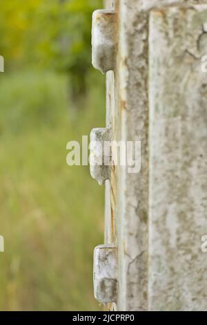 Screws on a high voltage pole, side view Stock Photo