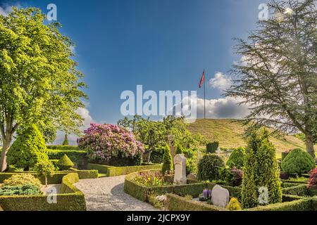 Danish national burial mounds monuments in Jelling Denmark Stock Photo