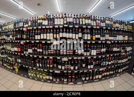 Fossano, Italy - June 09, 2022: Shelves with wine bottles for sale in Italian supermarket Stock Photo