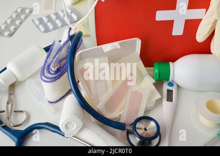 Hospital  assortment of basic first aid portable medical assistance equipment on white table. Horizontal composition. Elevated view. Stock Photo