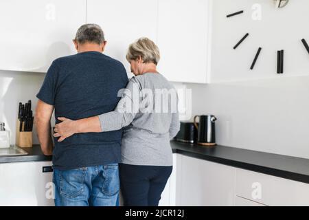 Happy romantic senior couple in love cooking together at home Stock Photo