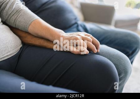 Happy romantic senior couple in love holding hands at home Stock Photo