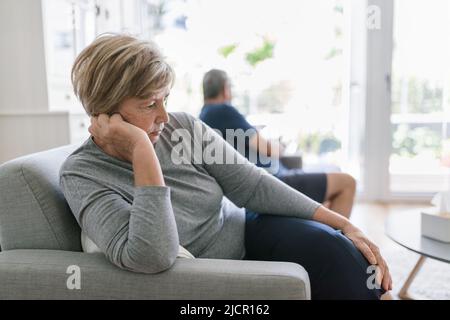 Upset senior couple at home in living room having an argument Stock Photo