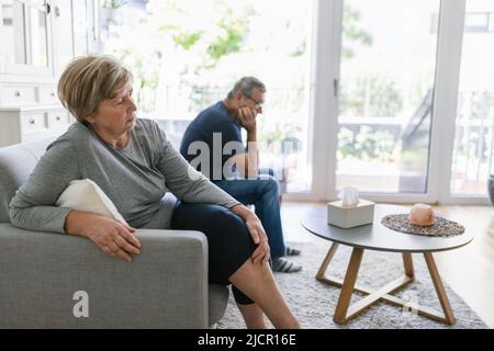 Upset senior couple at home in living room having an argument Stock Photo