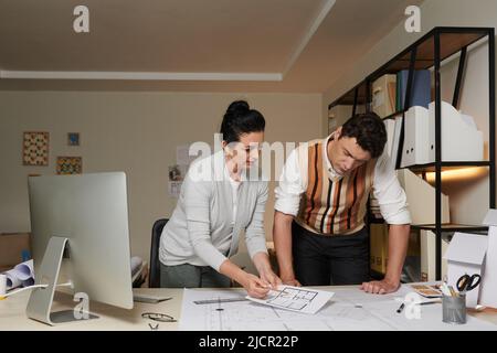 Team of experienced architects working on apartment building project at their bureau Stock Photo