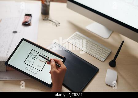 Closeup image of architect checking plan of house floor on tablet computer Stock Photo
