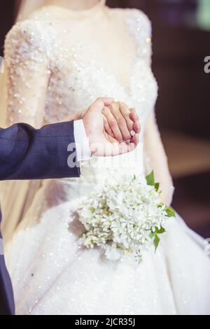 Newly wed couple holding hands in wedding day Stock Photo
