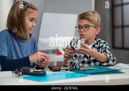 Pupils at school working with electronics component at robotics classroom. Stock Photo