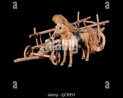 Model of vintage cart with brown horse isolated on black Stock Photo