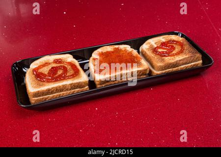 Delicious toast with jam; photo on a red background. Stock Photo