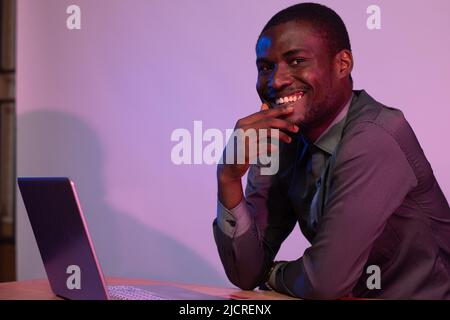 portrait of african man using his laptop smiling Stock Photo