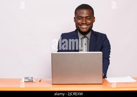 portrait of an african businessman smiling while working Stock Photo