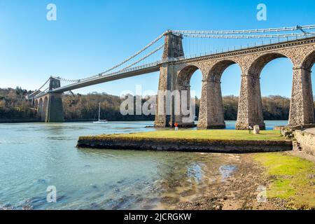 Menai Bridge, crossing the Menai Strait, designed by Thomas Telford, Anglesey, Wales, UK Stock Photo