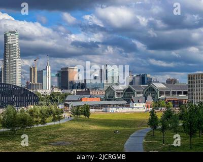 Brussels, Belgium - May 19, 2022: Cityscape of Brussels city,  skyscrapers in summer on a cloudy and sunny day with a dramatic sky. Green park in the Stock Photo