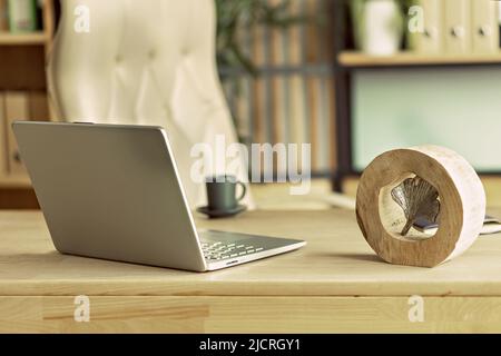 home office interior with wooden table, armchair,laptop, coffee set. office accessories Stock Photo