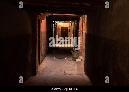 Shadows in an old underpass on an empty street in the historic walled city in the Medina in Marrakesh, Morocco. Stock Photo